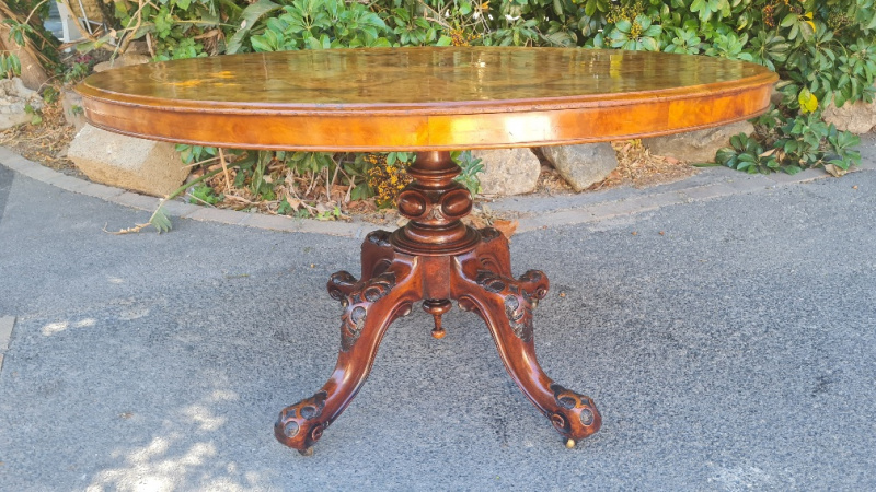 VICTORIAN WALNUT OVAL LOO TABLE ON CARVED PEDESTAL LEGS   PRICE: R16950.00 ; {135CM X 102 X 72H}
