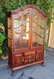 STINKWOOD GABLE TOP DISPLAY CABINET WITH BEVELLED GLASS. SIZE: 130CM X 50 X 206H